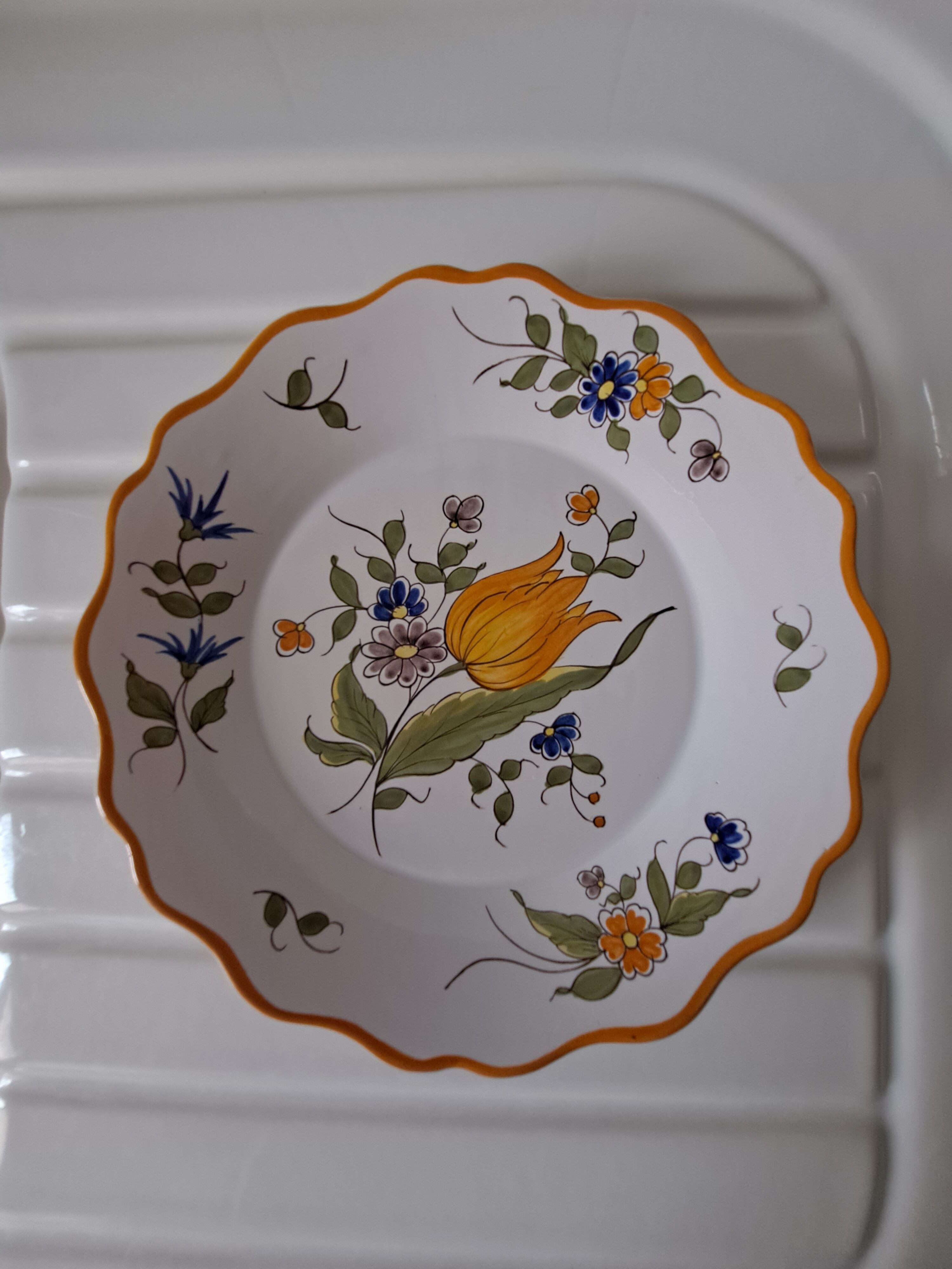 Glazed terracotta cap plate with yellow tulip