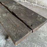 Dark brown wood and black cast-iron antique garden bench with weathered solid-wood seat