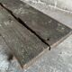 Dark brown wood and black cast-iron antique garden bench with weathered solid-wood seat