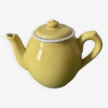 Small lemon yellow porcelain teapot with filter