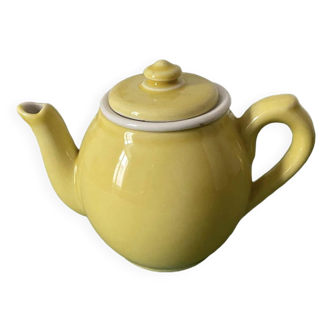 Small lemon yellow porcelain teapot with filter