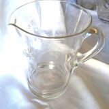Blown glass pitcher decorated with small flowers