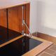 Vintage teak bar cabinet with black glass interior.