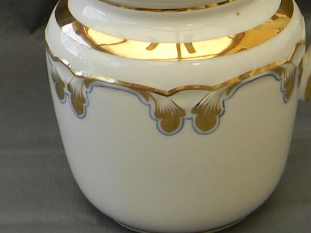 Milk jug or antique pitcher in white and gold porcelain.