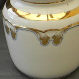 Milk jug or antique pitcher in white and gold porcelain.