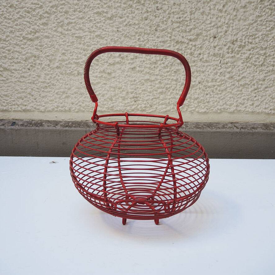 Old red-painted metal egg basket