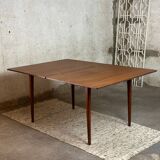 Extendable teak and teak veneer dining table