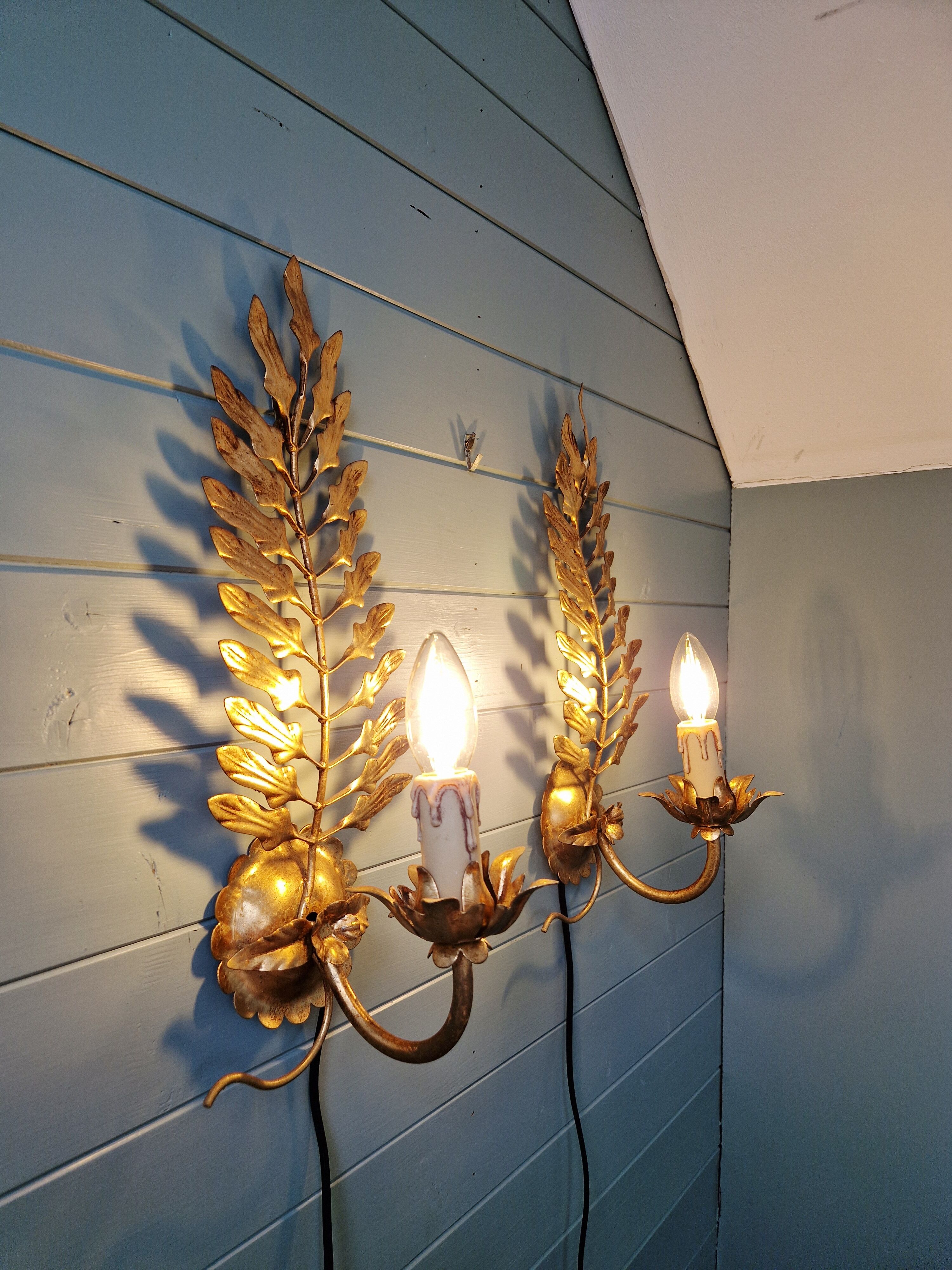 Pair of gold metal wall sconces in Hollywood Regency style, 1970s.