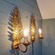 Pair of gold metal wall sconces in Hollywood Regency style, 1970s.