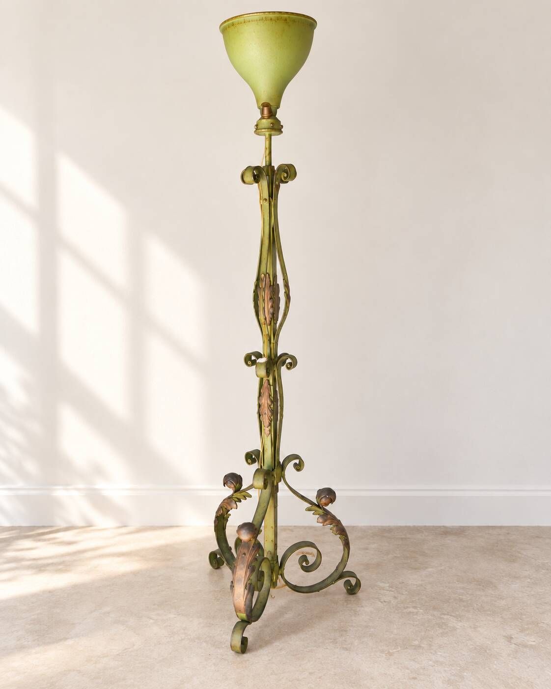 Antique green-painted iron floor lamp with a floral design.