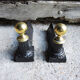 Old cast iron and brass andirons in neoclassical style