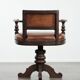 Elegant antique sheepskin leather desk chair with a heavy wooden frame