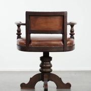 Elegant antique sheepskin leather desk chair with a heavy wooden frame