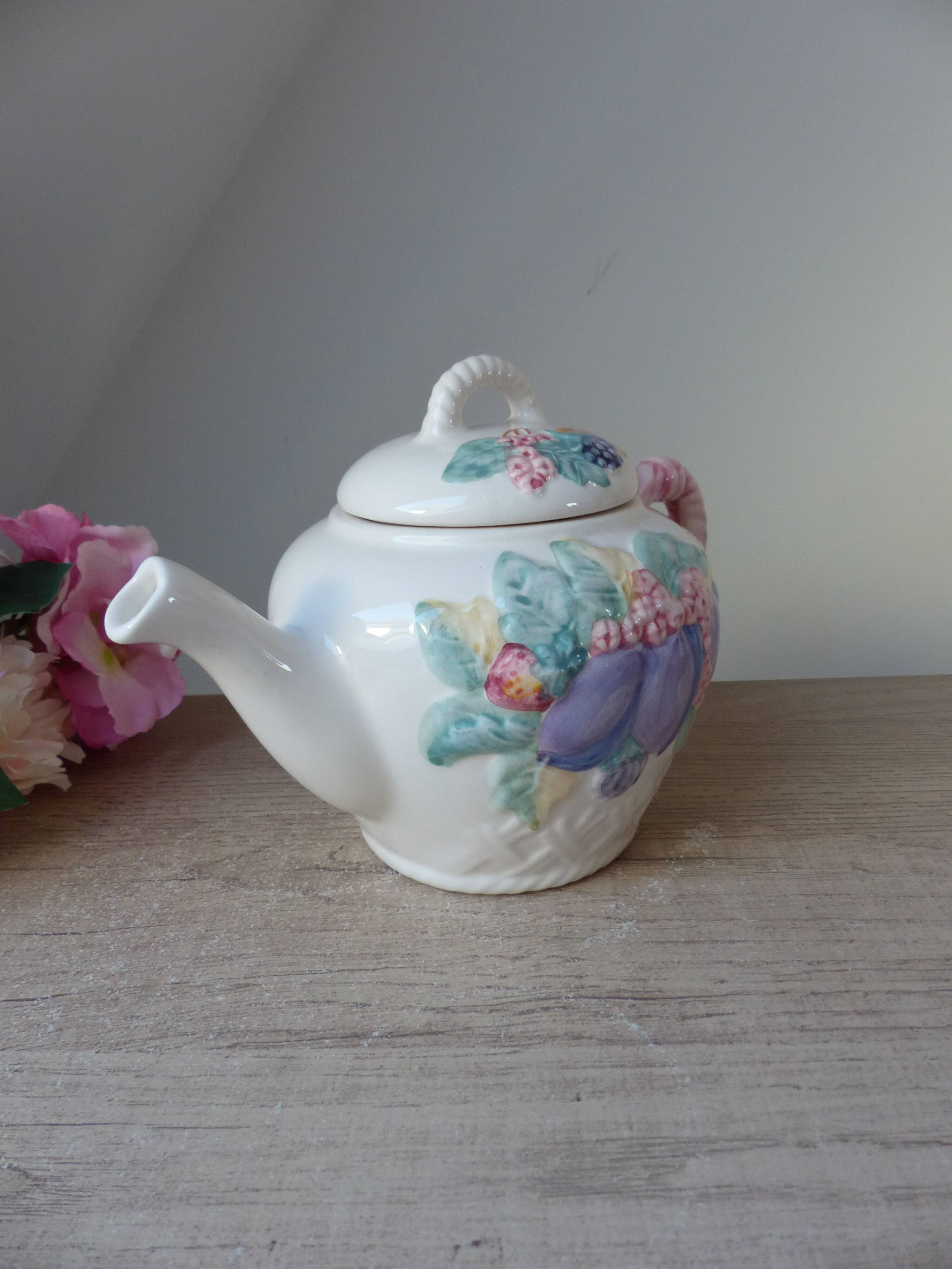 Old ceramic teapot in the shape of a basket of fruits from the garden