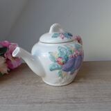 Old ceramic teapot in the shape of a basket of fruits from the garden