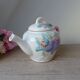 Old ceramic teapot in the shape of a basket of fruits from the garden