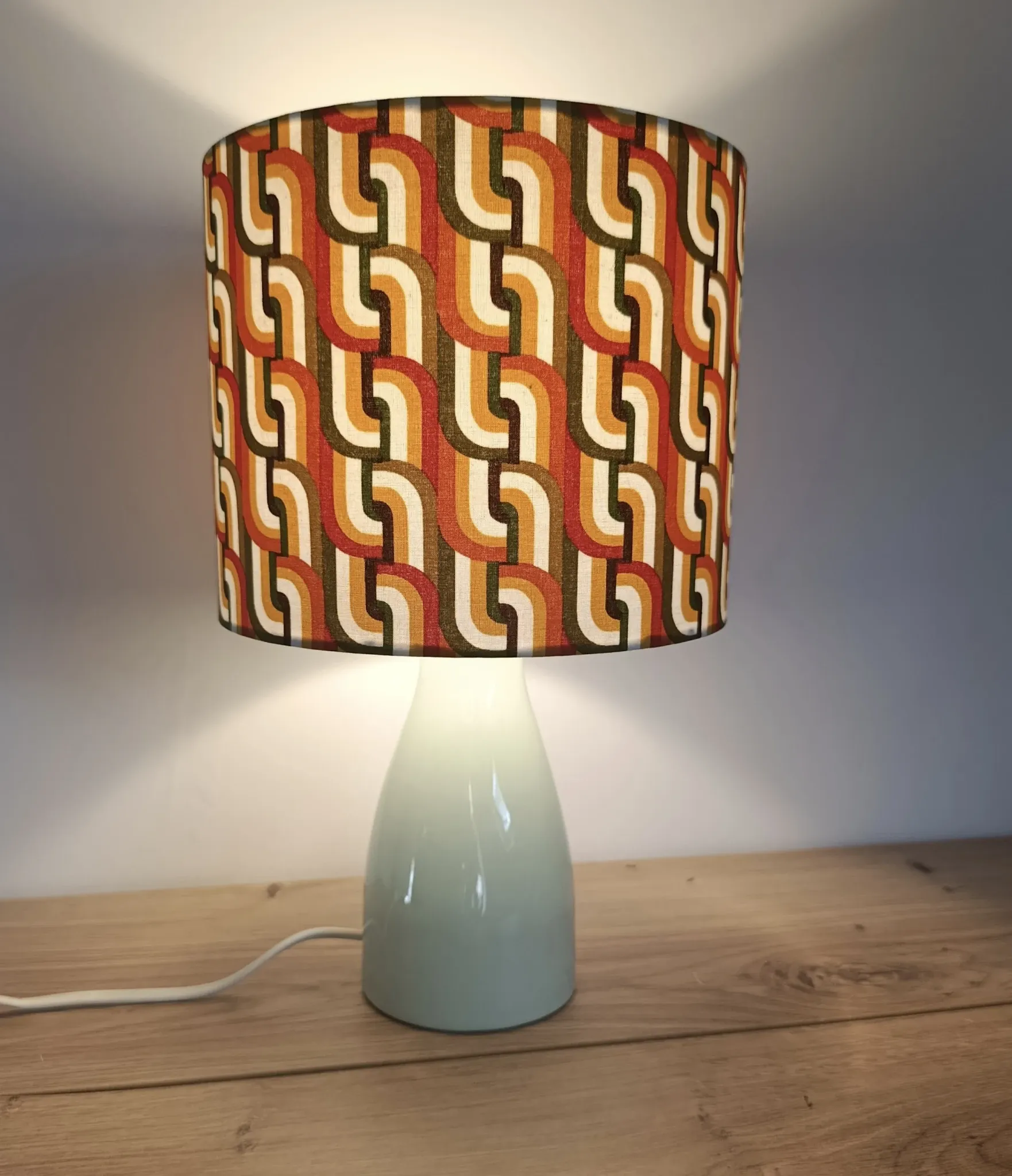 Seventies spirit lamp with geometric orange/green lampshade.