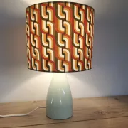 Seventies spirit lamp with geometric orange/green lampshade.