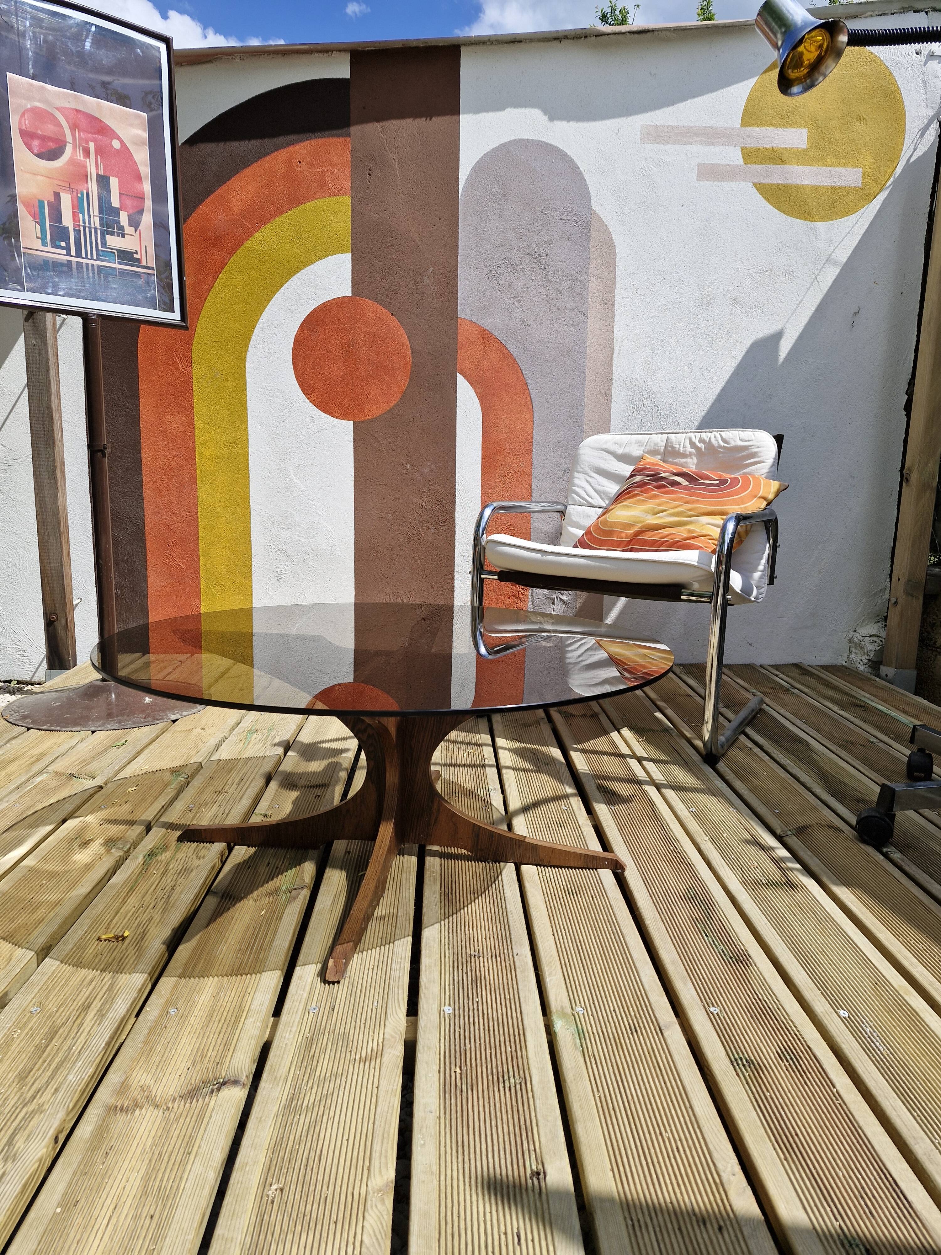 Vintage coffee table from the 60s and 70s by Hugues POIGNANT, smoked glass & teak.