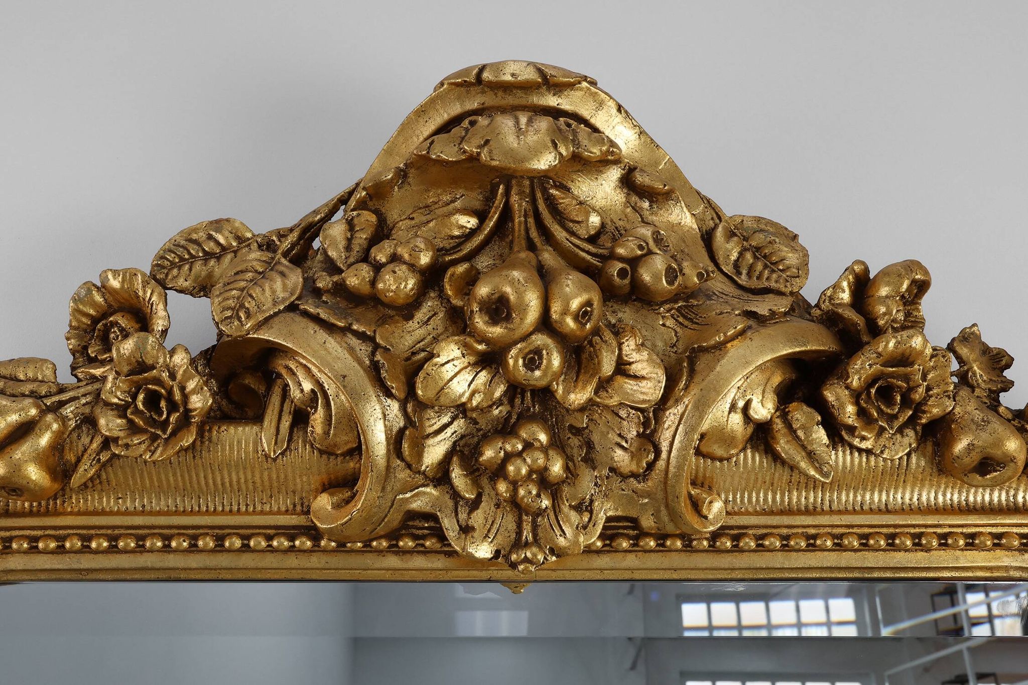 Baroque mantel mirror in carved wood and gilded plaster, France circa 1850.