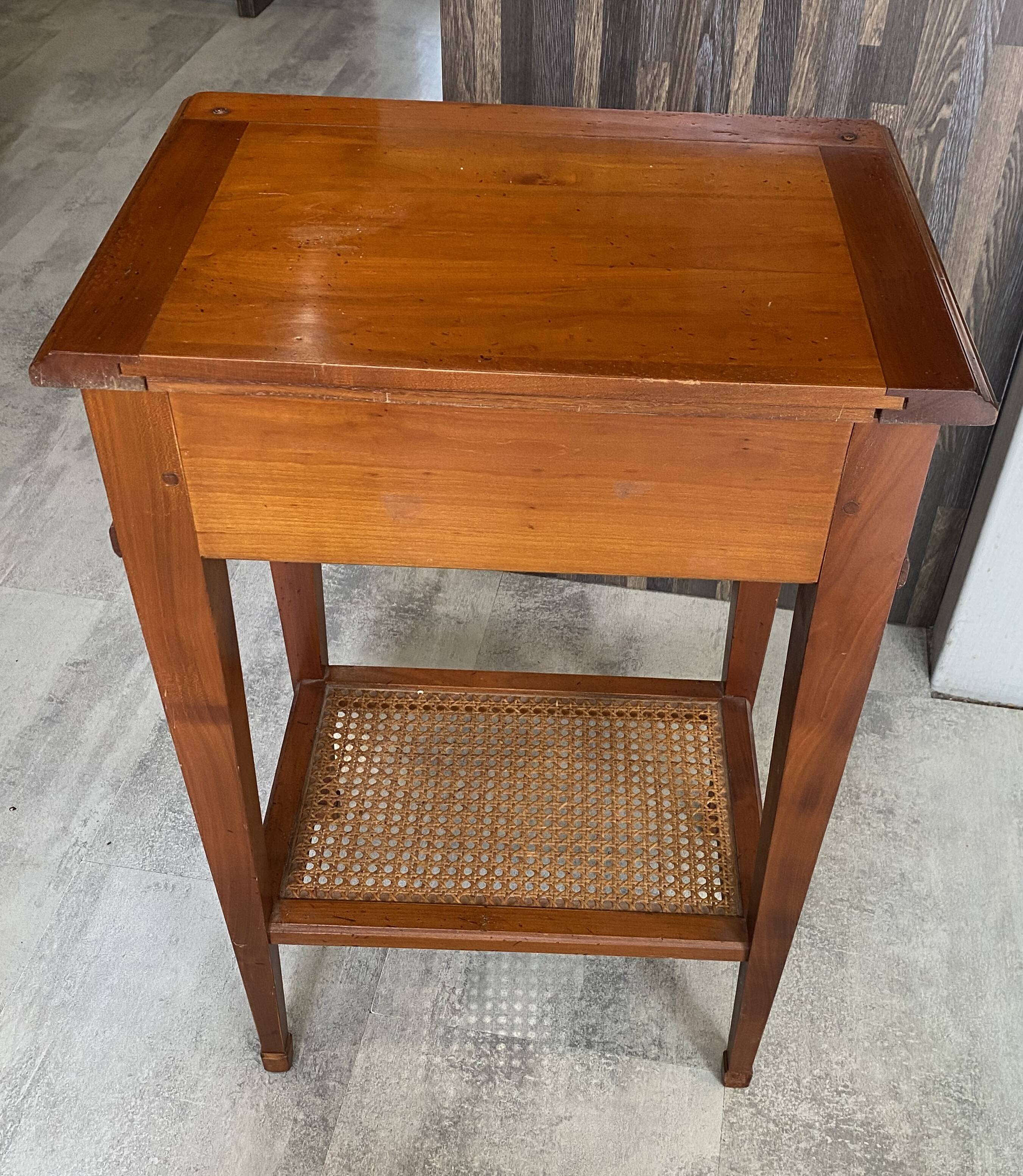 Occasional table in cherry wood, 1 drawer, 1 cane shelf, 1950.