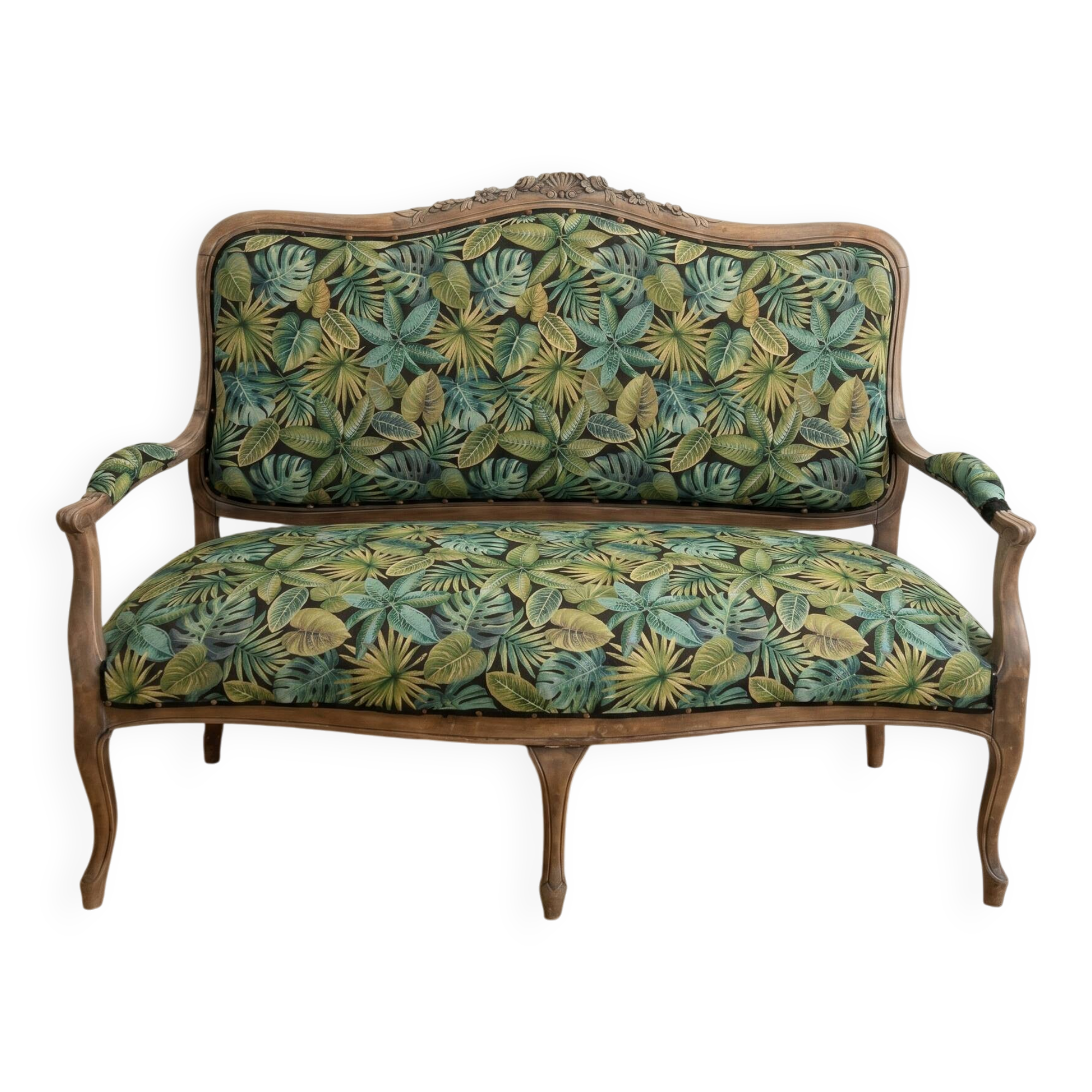 Louis XV bench reupholstered with a green tropical pattern.