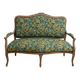 Louis XV bench reupholstered with a green tropical pattern.