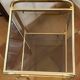 Gold metal and smoked glass console table.