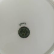 12 assiettes en porcelaine de Limoges à décor de guirlandes et de fruits