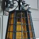 Wrought iron wall lantern & amber cathedral glass