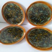 Set of 4 flamed enamel plates in green and amber from the 60s-70s.