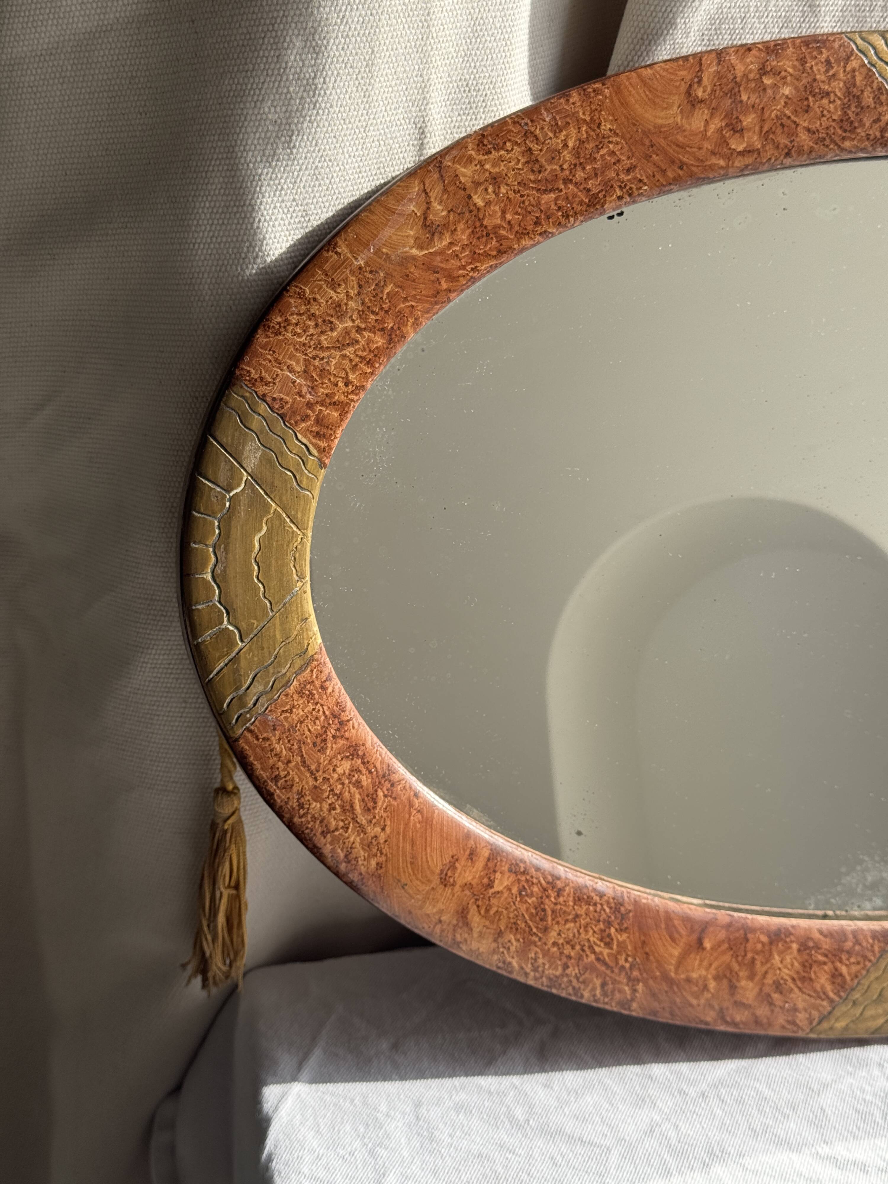 Small oval Art Deco mirror in brown and gold 33x54.