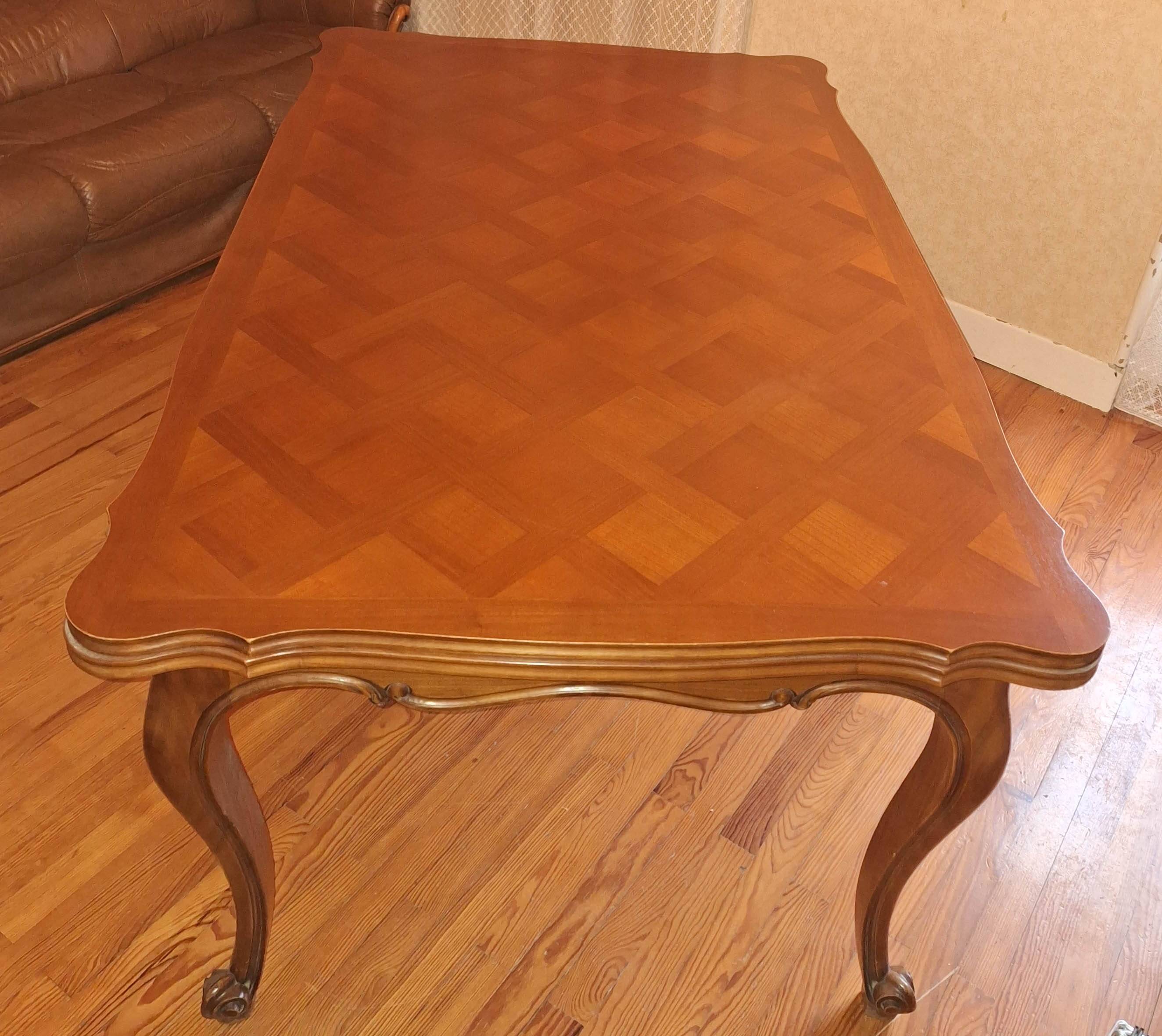 Extendable table in Louis XV style made of solid cherry wood and marquetry.