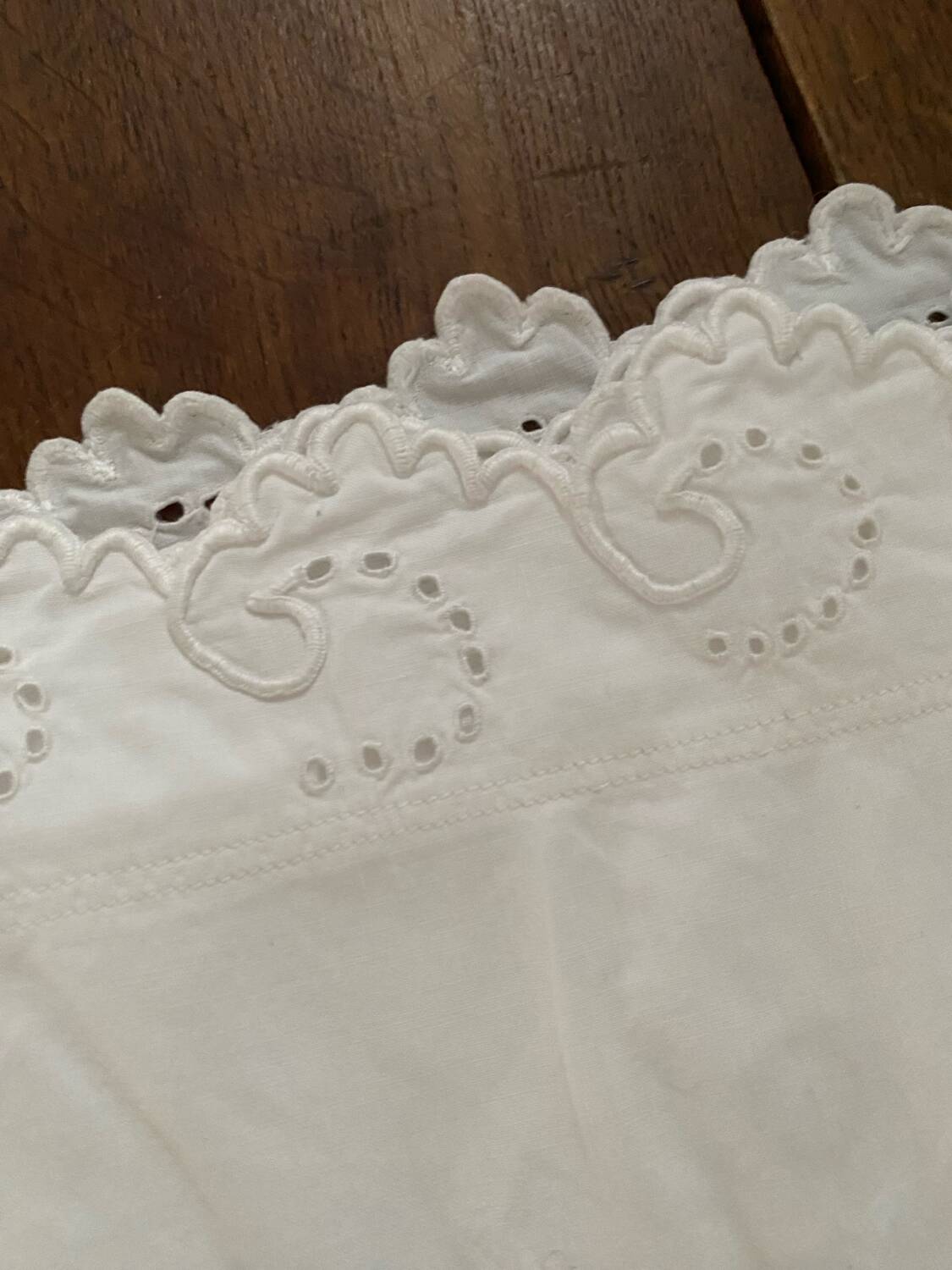 White cotton pillowcase with embroidery and monogram.