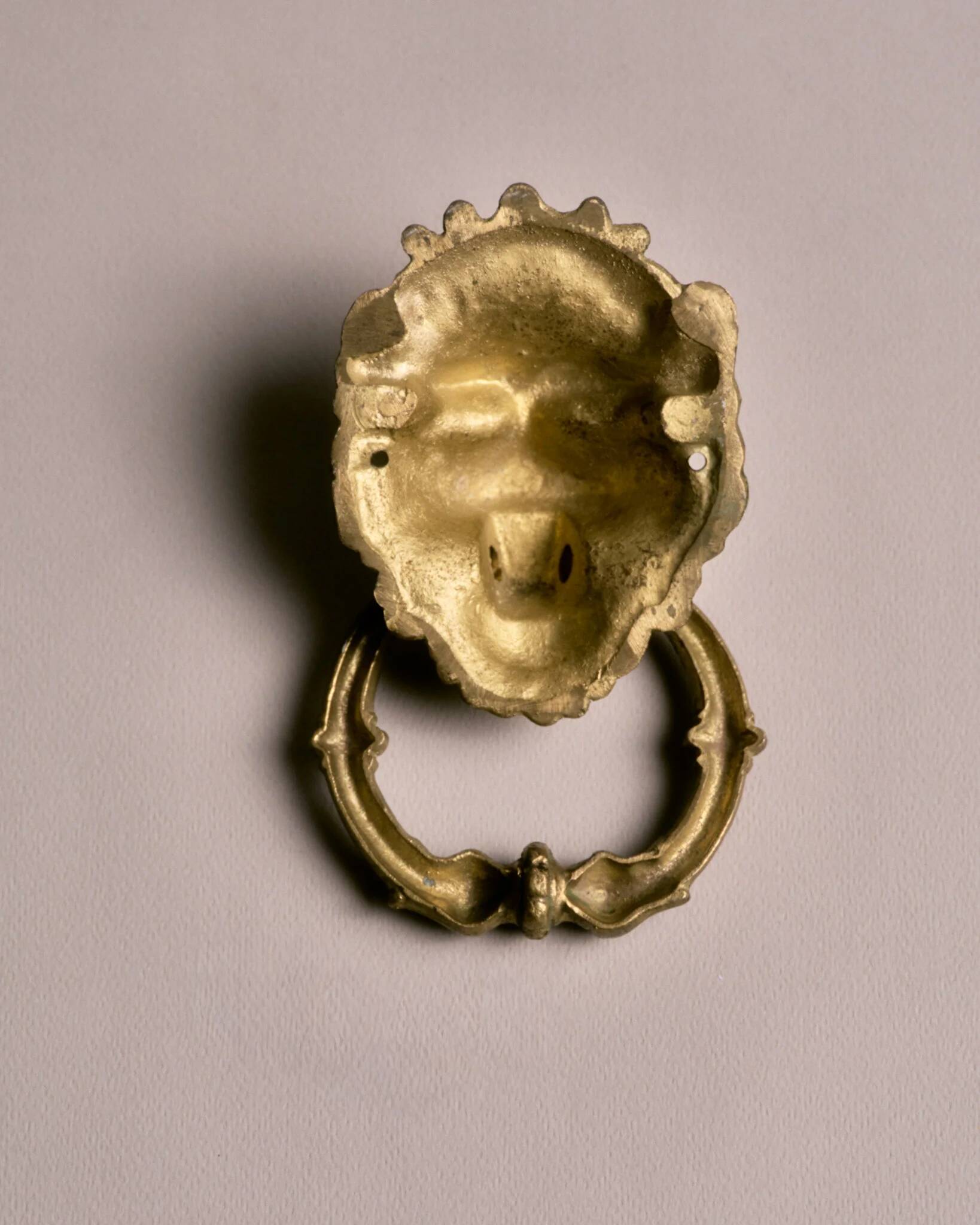 Lion door knocker, in brass