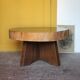 Brutalist wooden coffee table, cruciform leg with a tree trunk top.