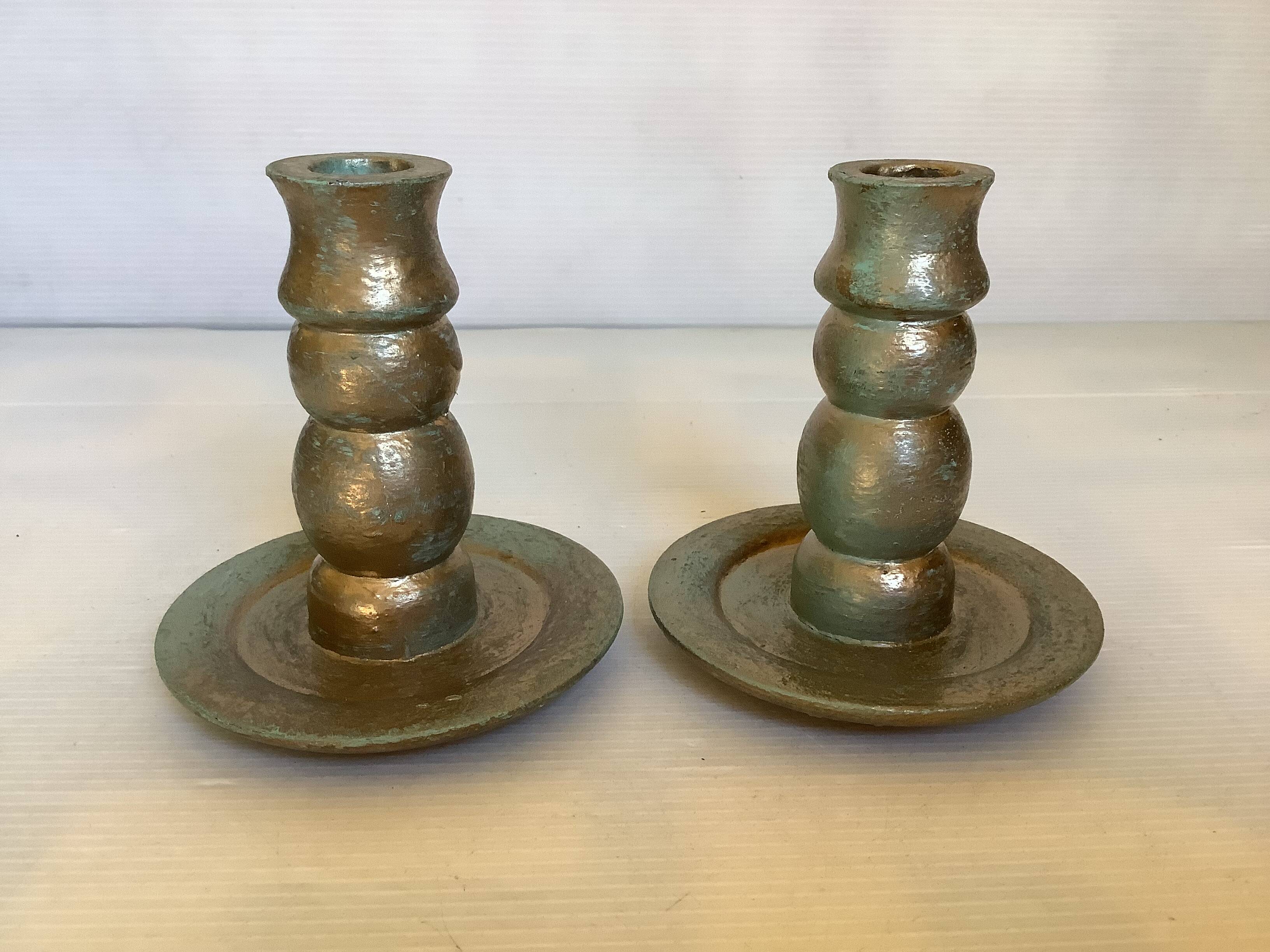 Pair of green and gold wooden candlesticks