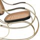 Modernist rocking chair in gilded brass and cane.