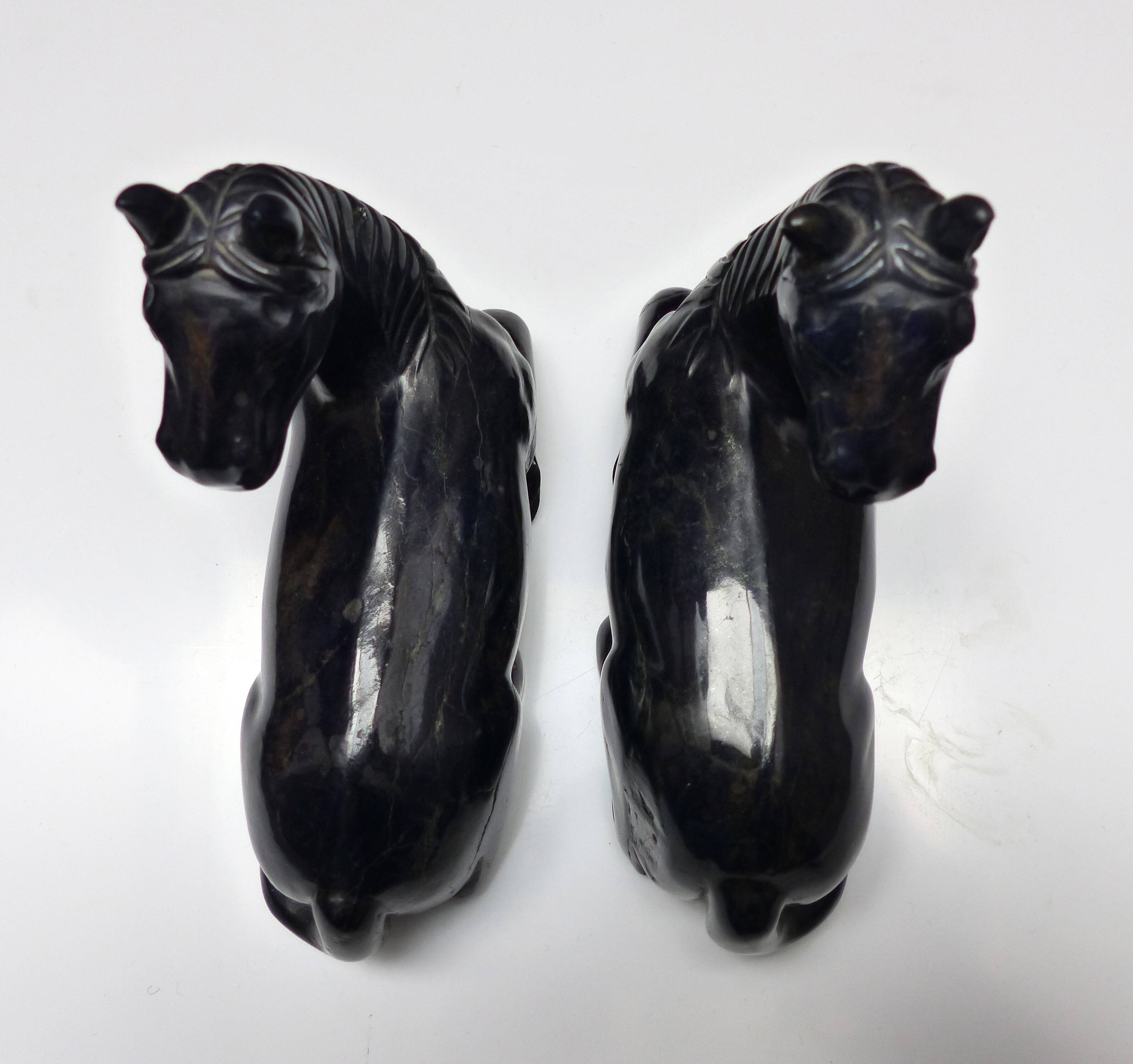 Black marble bookends with lying horses