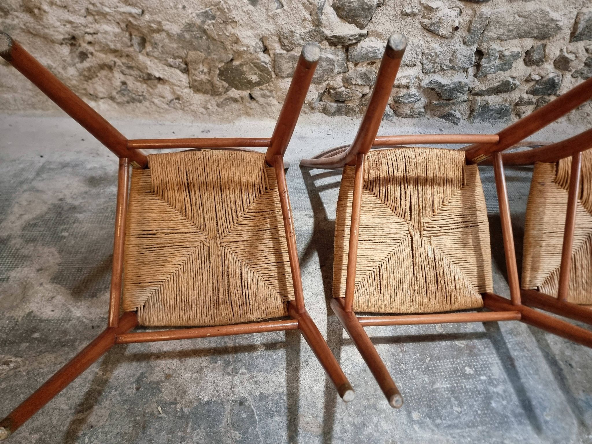 Set of 4 mid-century Italian dining chairs with woven seats, circa 1950–1970.