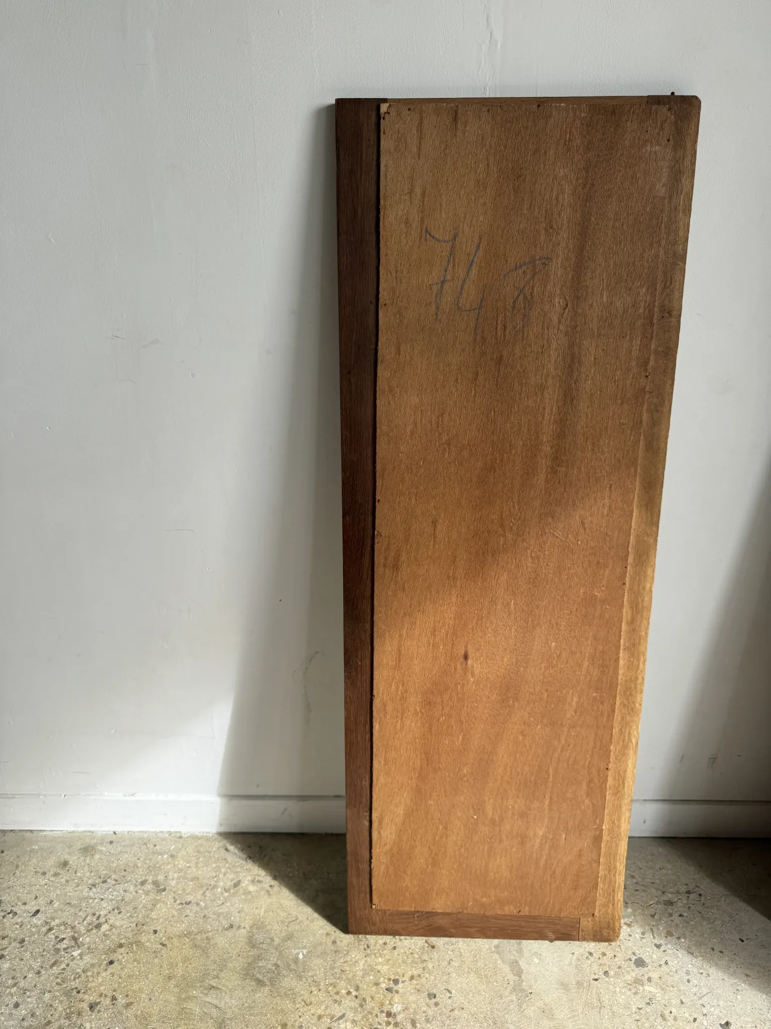 Antique mirror door (left) of a brown oak wardrobe with bevelled glass.