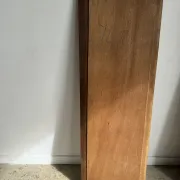 Antique mirror door (left) of a brown oak wardrobe with bevelled glass.
