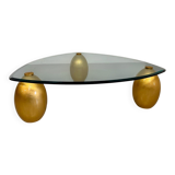 Vintage Italian design coffee table with a glass top and gold base, dating from the 1980s.