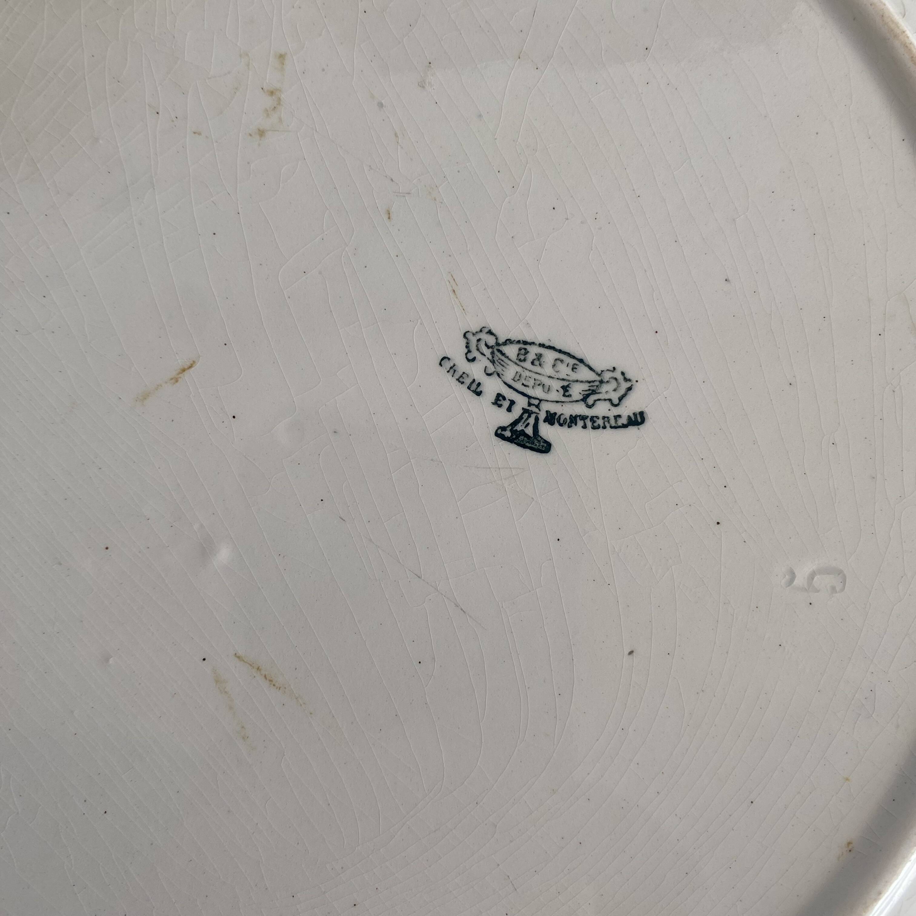 Set of large round white earthenware dishes from Creil and Montereau, 19th century