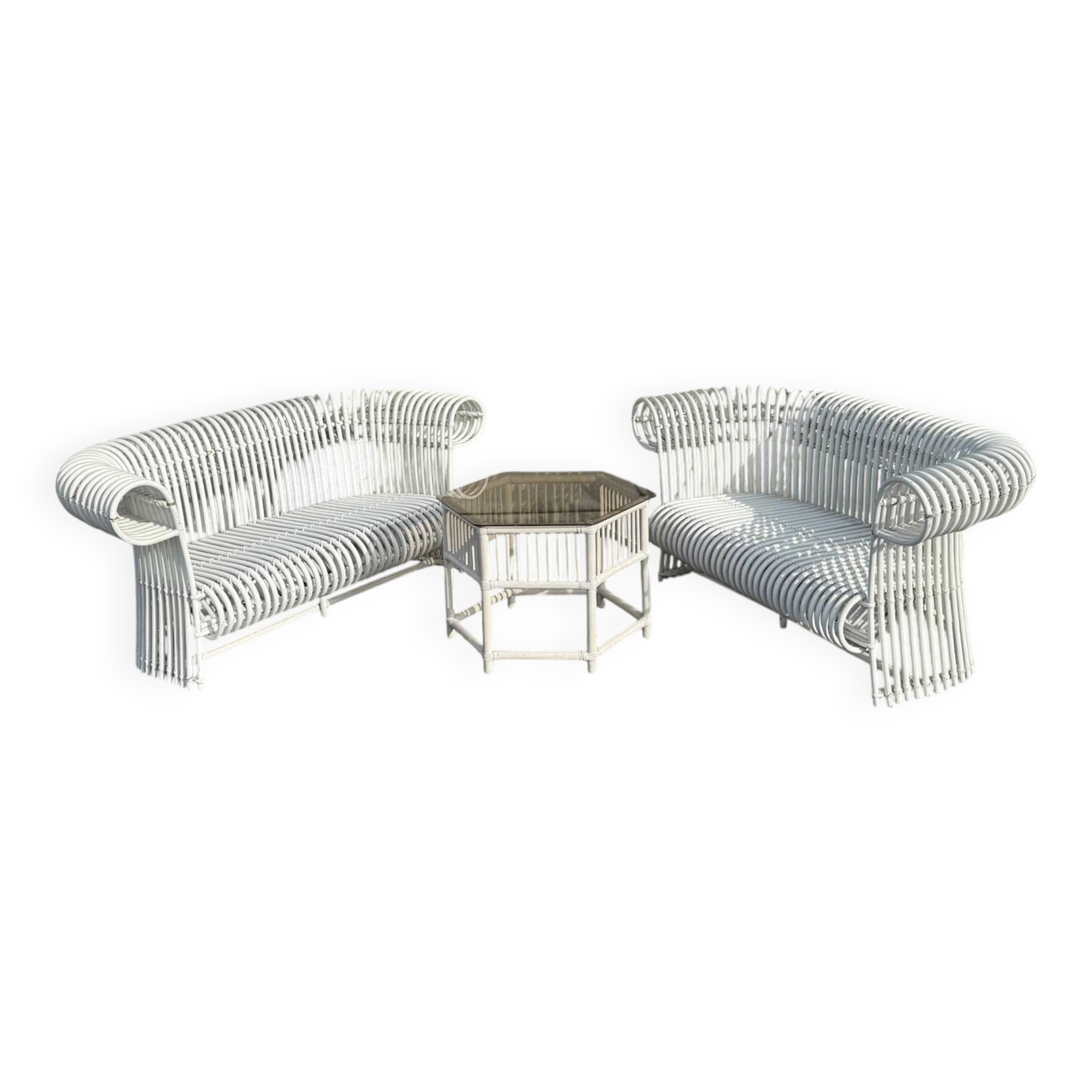 Rattan lounge with two two-seater sofas and a white coffee table.