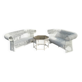 Rattan lounge with two two-seater sofas and a white coffee table.