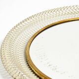 Mid Century Modern round wall mirror with a white expanded metal frame