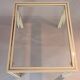 White lacquered side table by Pierre Vandel with gold brass.