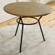 Tripod coffee table with a straw covering.