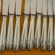 Set of 12 cheese or fruit knives handle in silver metal.